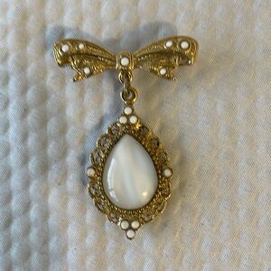 Vintage Gold Tone Oval Dangle Brooch with center white glass stone. 1.75. x 1.25